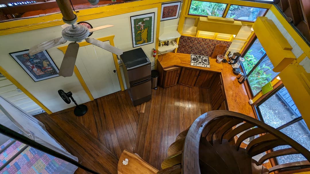 View down from upstairs onto the kitchen, fridge and the curved Nispero spiral staircase